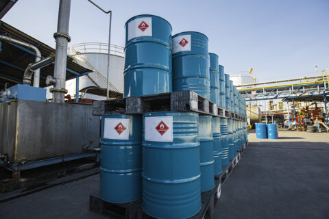 Chemical drums with hazard labels at an industrial facility